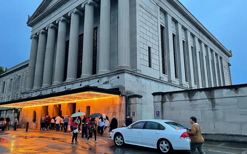 Stambaugh Auditorium's columned facade lit at dusk in Youngstown